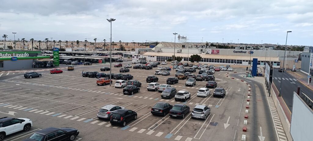 An open-space supermarket car park.