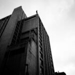 A vulnerable person atop a large concrete building